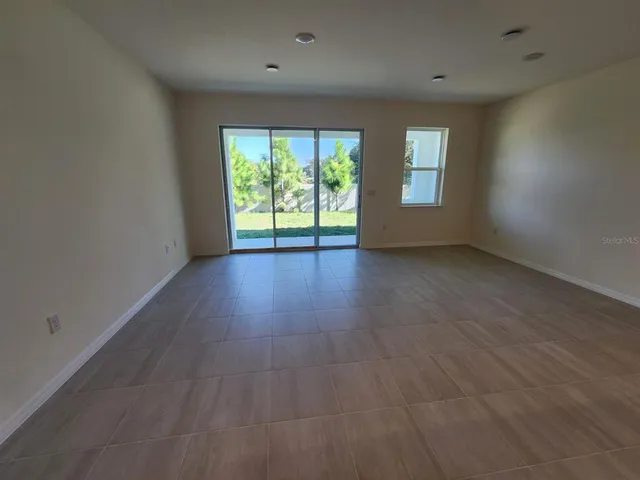 a kitchen with kitchen island granite countertop a sink a counter top space appliances and cabinets