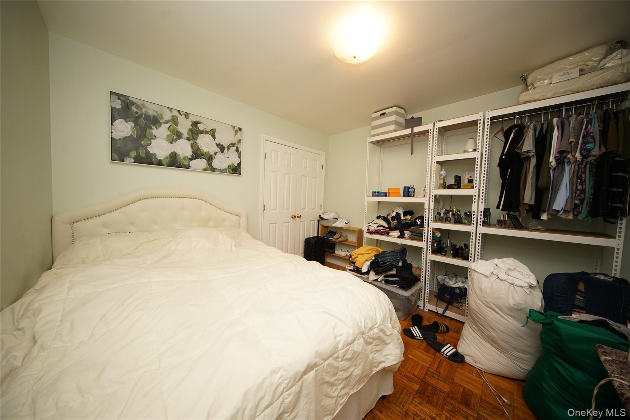 109-12 Westside Avenue Queens, NY 11368 - Photo 11 of 16 a bedroom with bed and wooden floor