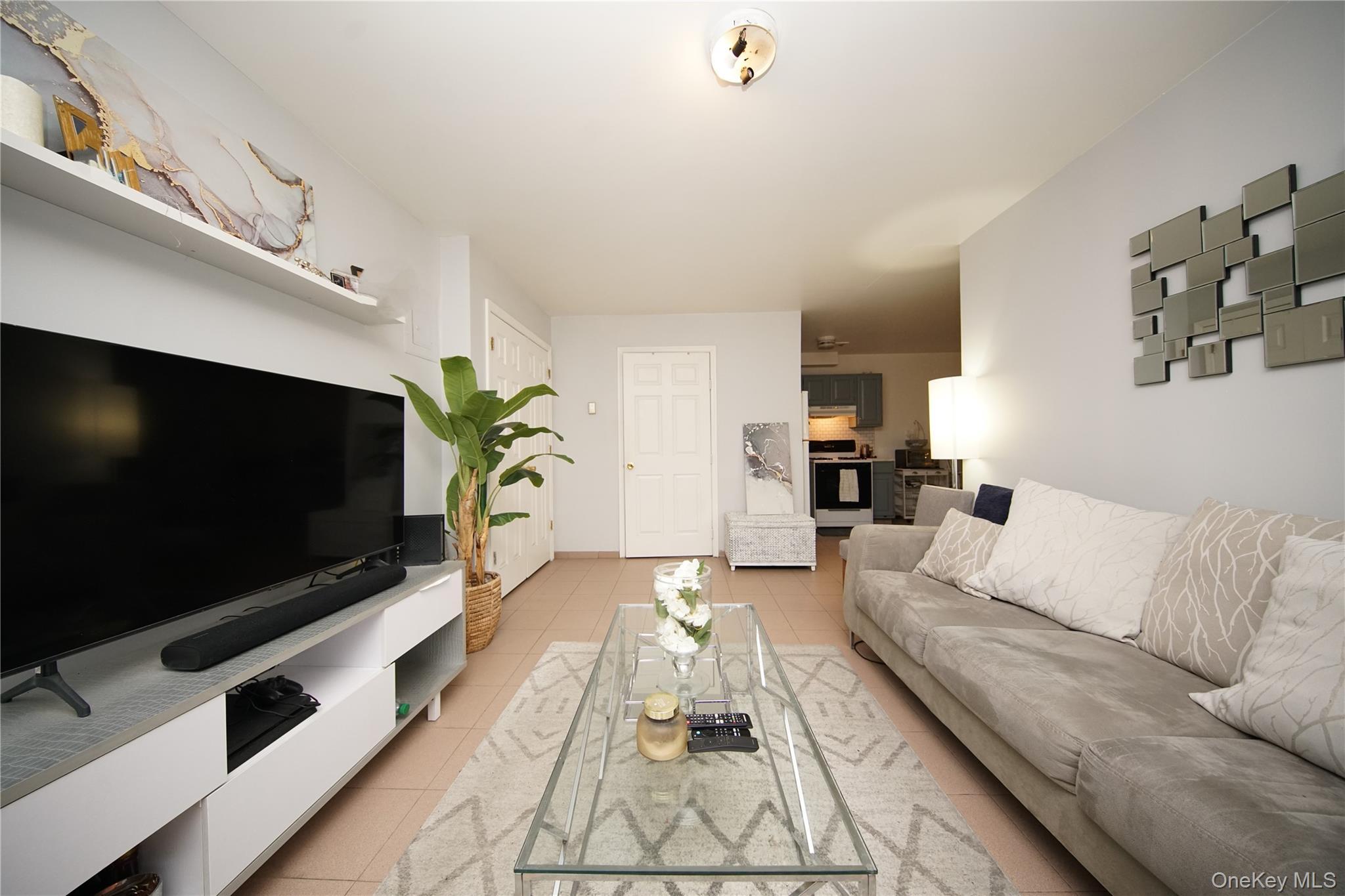 109-12 Westside Avenue Queens, NY 11368 - Photo 4 of 16 a living room with furniture and a flat screen tv