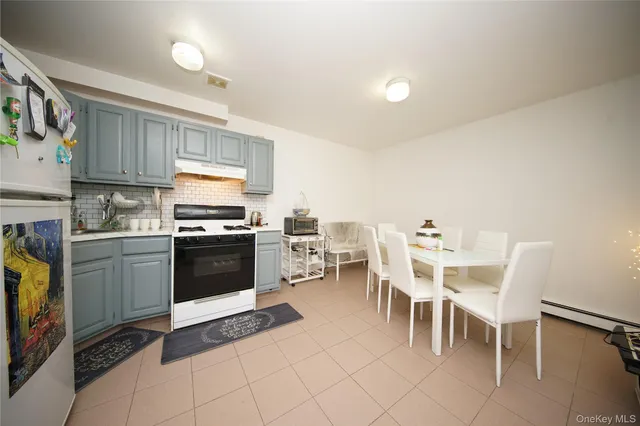 a kitchen with a table chairs microwave and cabinets