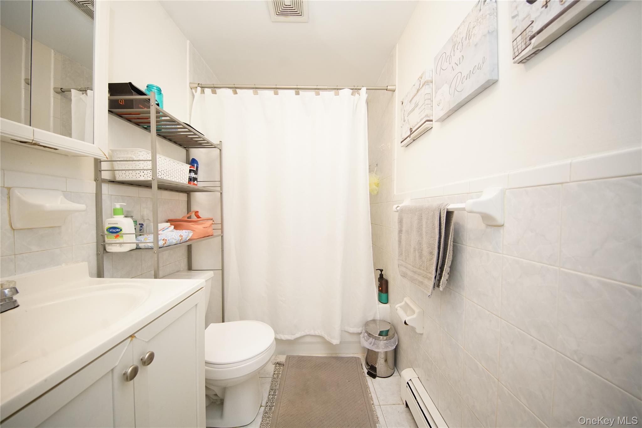 109-12 Westside Avenue Queens, NY 11368 - Photo 8 of 16 a bathroom with a sink toilet and shower