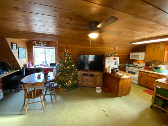 a living room with furniture a dining table and kitchen view