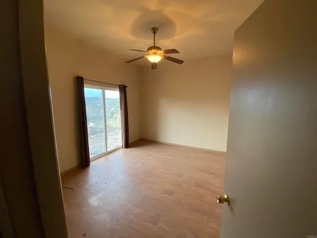 a view of an empty room with a fan