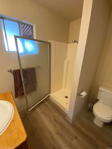 a bathroom with a toilet and a shower