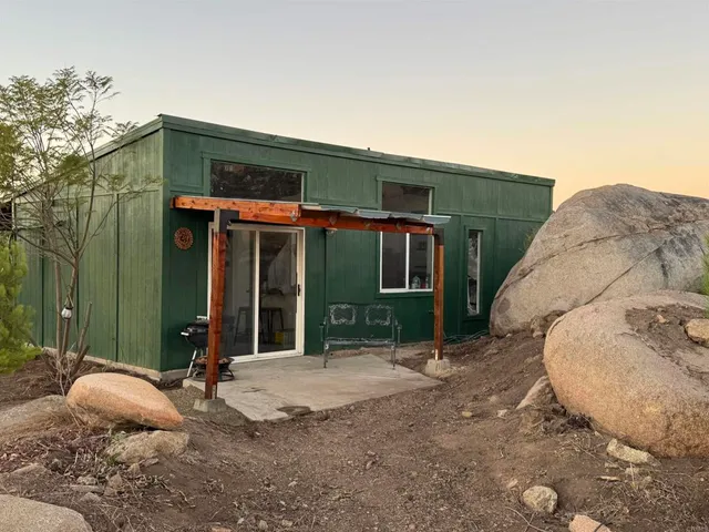 a backyard of a house with table and chairs