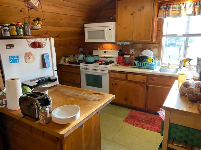 a kitchen with a sink a stove and a refrigerator
