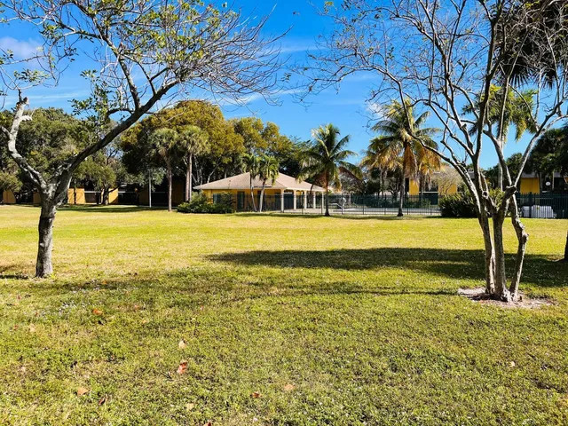 a view of a yard with swimming pool