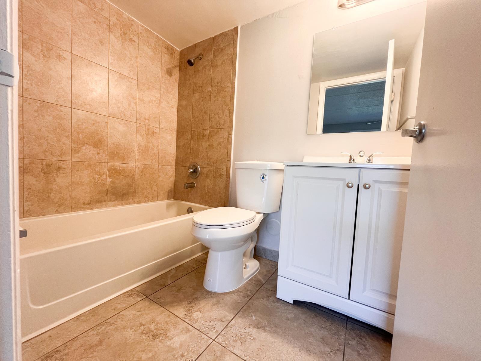 1106 Meadows Circle Boynton Beach, FL 33436 - Photo 2 of 16 a bathroom with a toilet sink and mirror