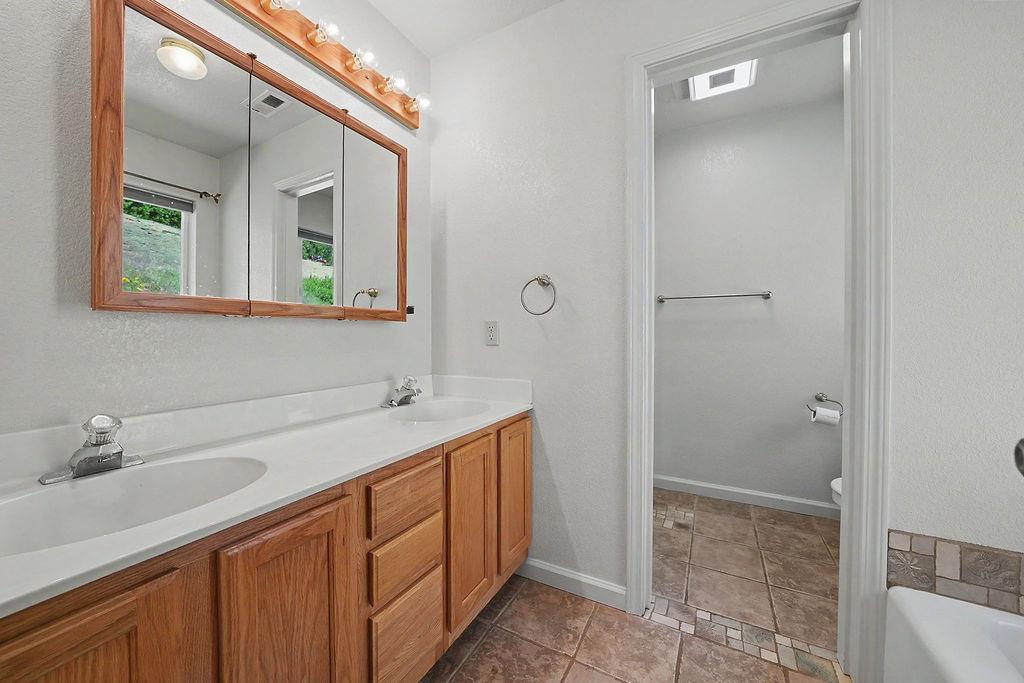 26845 Spring Court Pioneer, CA 95666 - Photo 38 of 89 a bathroom with a sink and a mirror