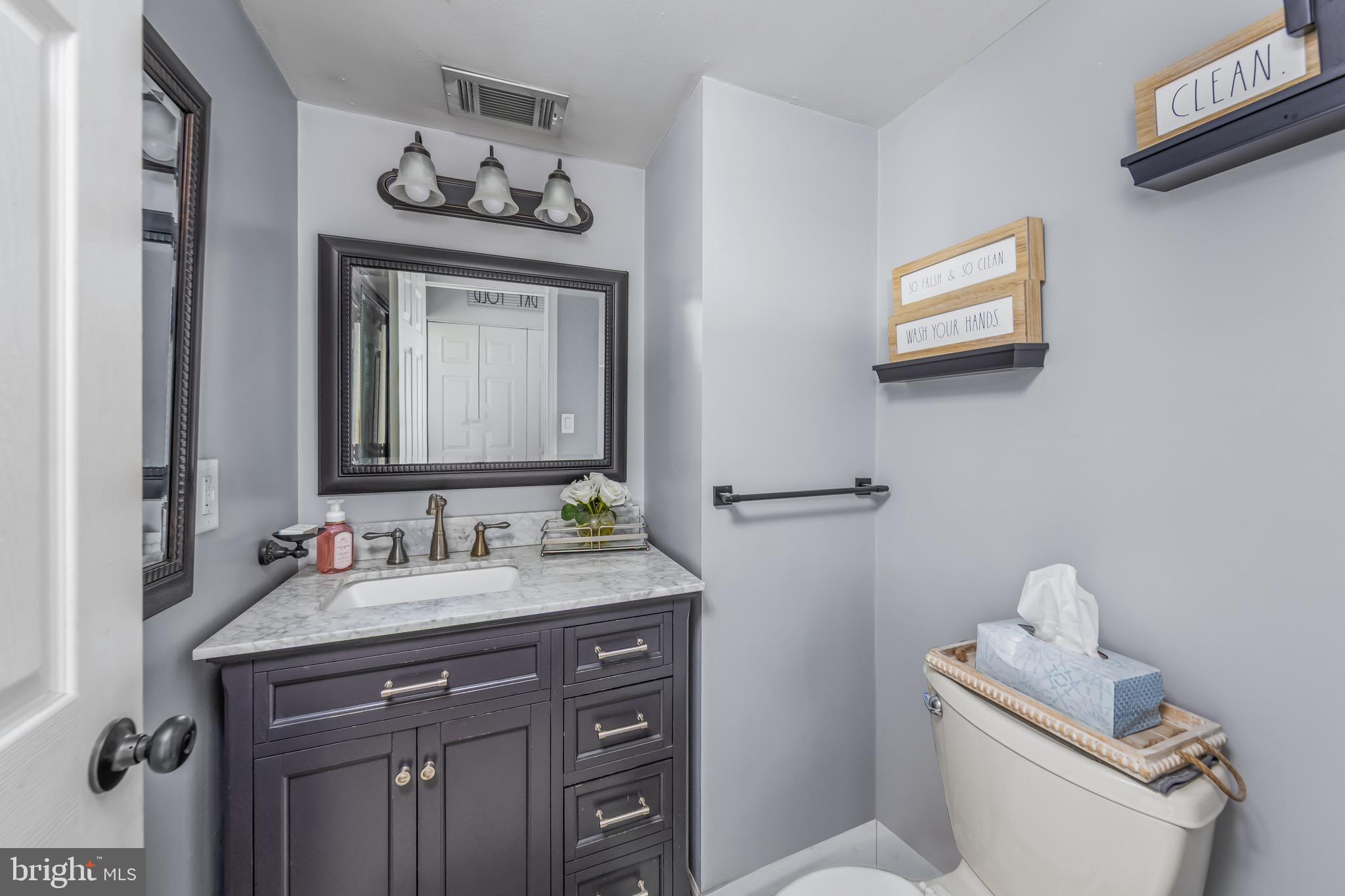 578 Eldridges Hill Road Pilesgrove, NJ 08098 - Photo 11 of 20 a bathroom with a sink mirror vanity and toilet