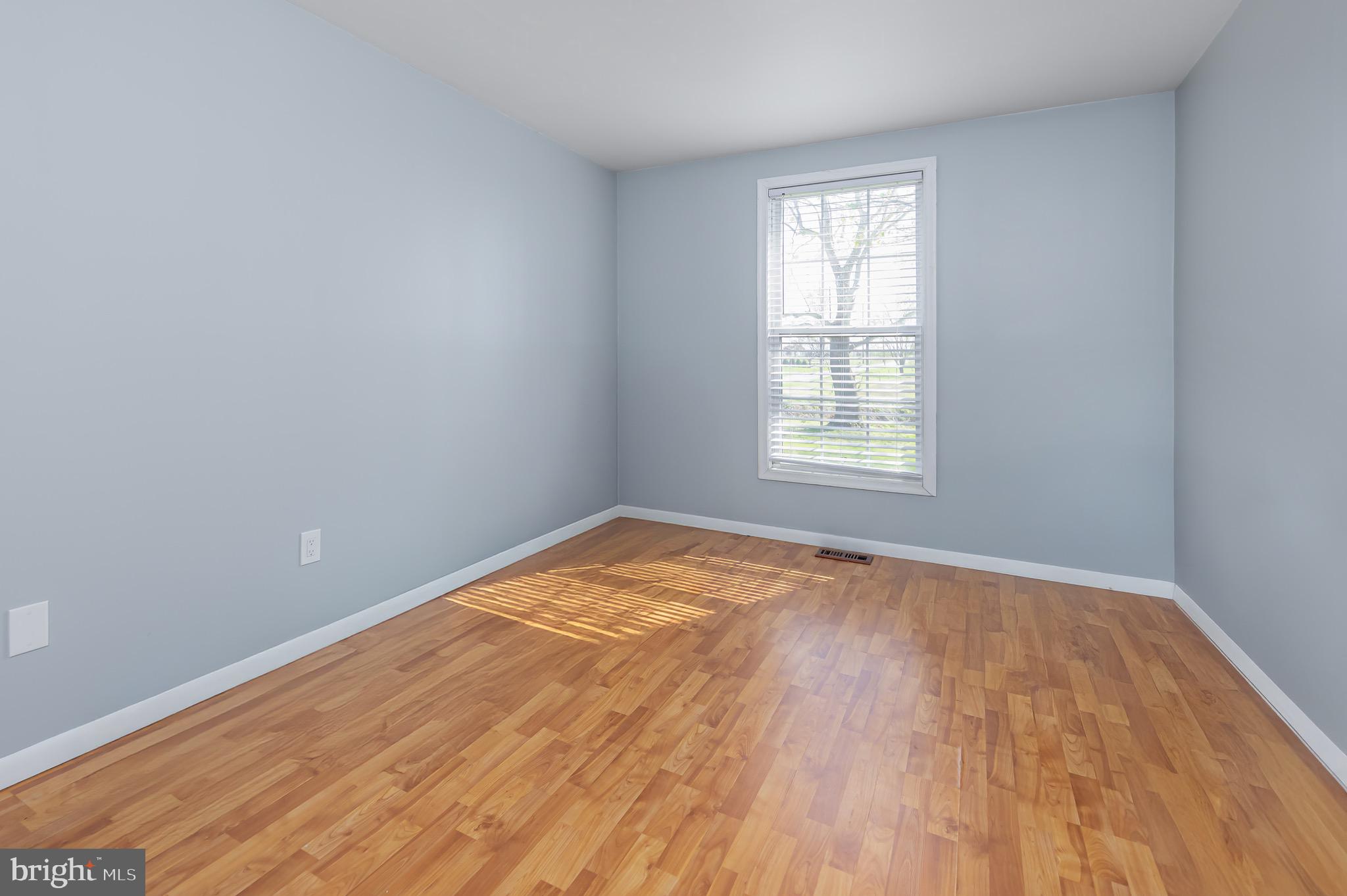 578 Eldridges Hill Road Pilesgrove, NJ 08098 - Photo 13 of 20 an empty room with wooden floor and windows