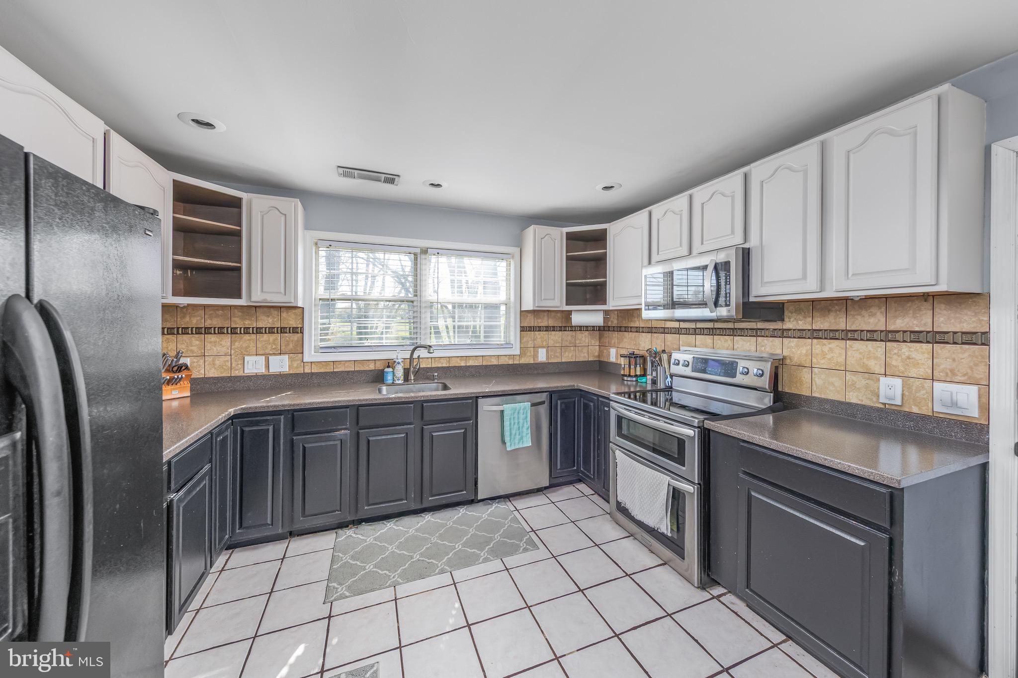 578 Eldridges Hill Road Pilesgrove, NJ 08098 - Photo 8 of 20 a kitchen with stainless steel appliances granite countertop a stove sink and cabinets