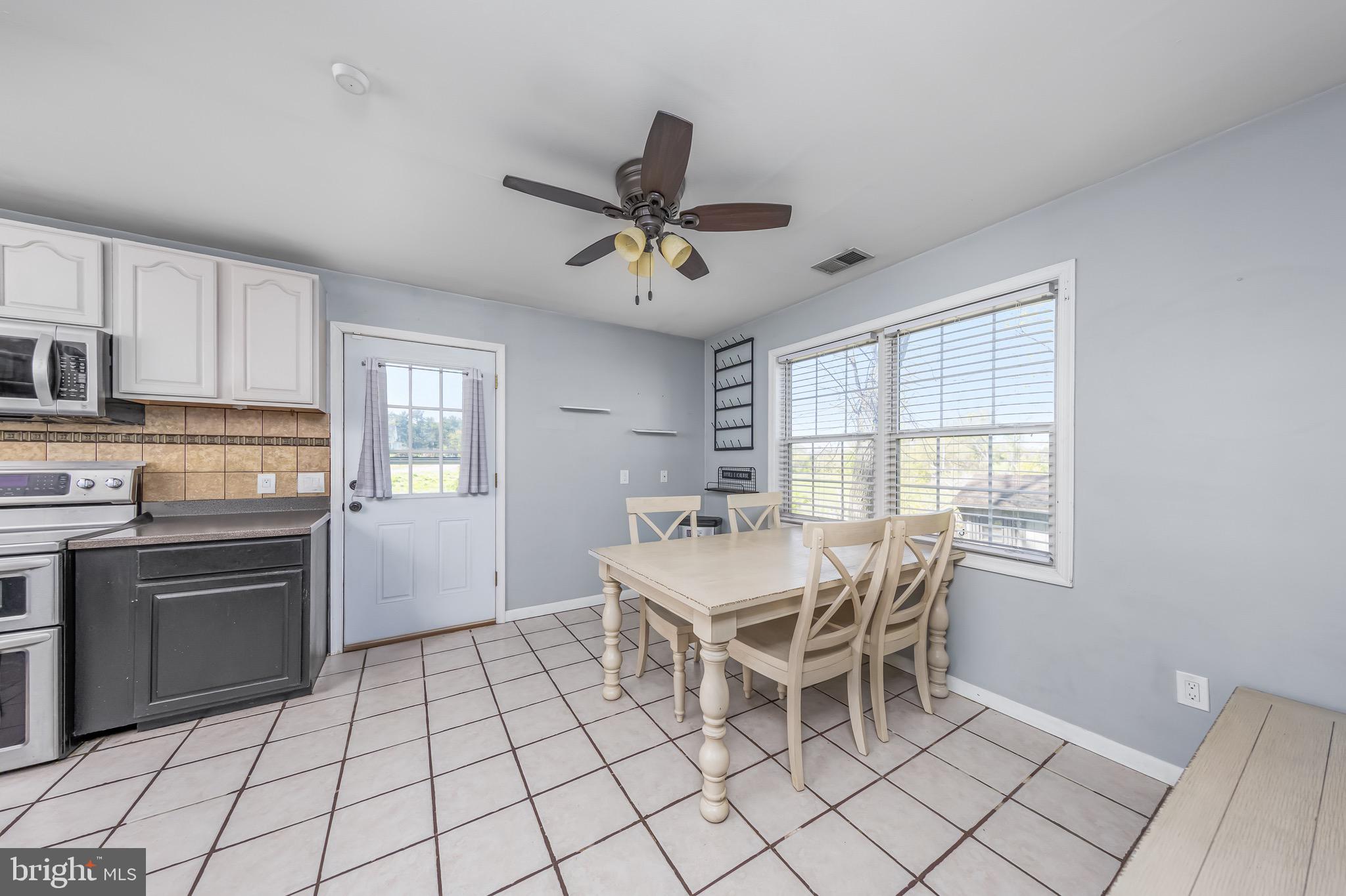 578 Eldridges Hill Road Pilesgrove, NJ 08098 - Photo 9 of 20 a white kitchen with a stove a sink and a refrigerator