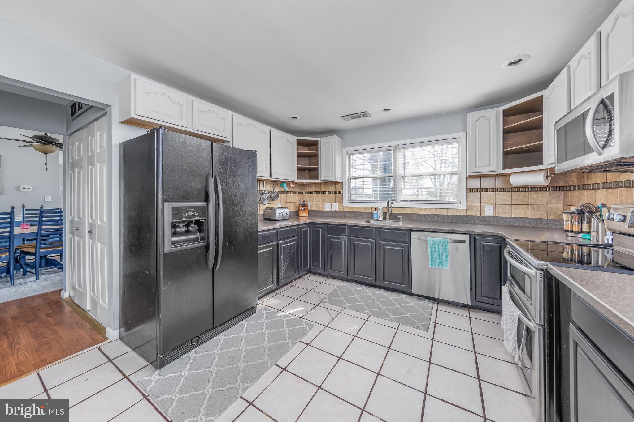 578 Eldridges Hill Road Pilesgrove, NJ 08098 - Photo 10 of 20 a kitchen with stainless steel appliances granite countertop a stove a sink dishwasher a refrigerator and a refrigerator
