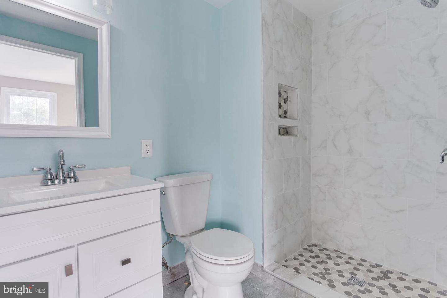 304 Crescendo Way Silver Spring, MD 20901 - Photo 16 of 29 a bathroom with a sink a toilet and shower