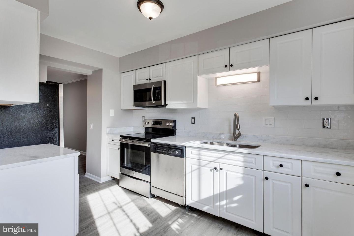 304 Crescendo Way Silver Spring, MD 20901 - Photo 10 of 29 a kitchen with appliances a sink and cabinets