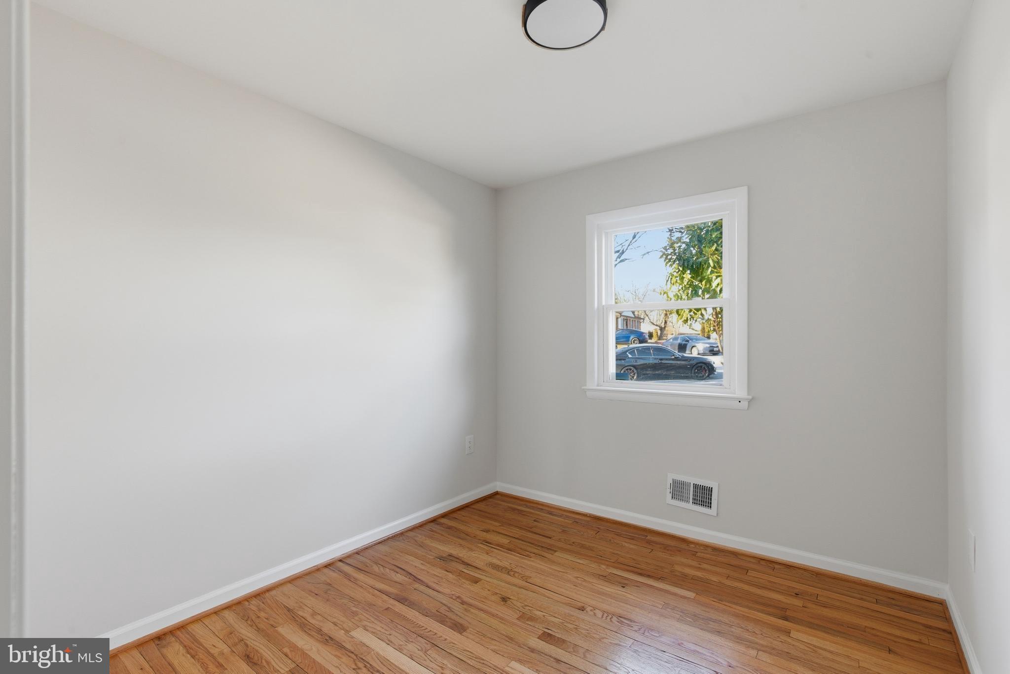 709 Quarry Avenue Capitol Heights, MD 20743 - Photo 15 of 43 a view of an empty room with wooden floor and window