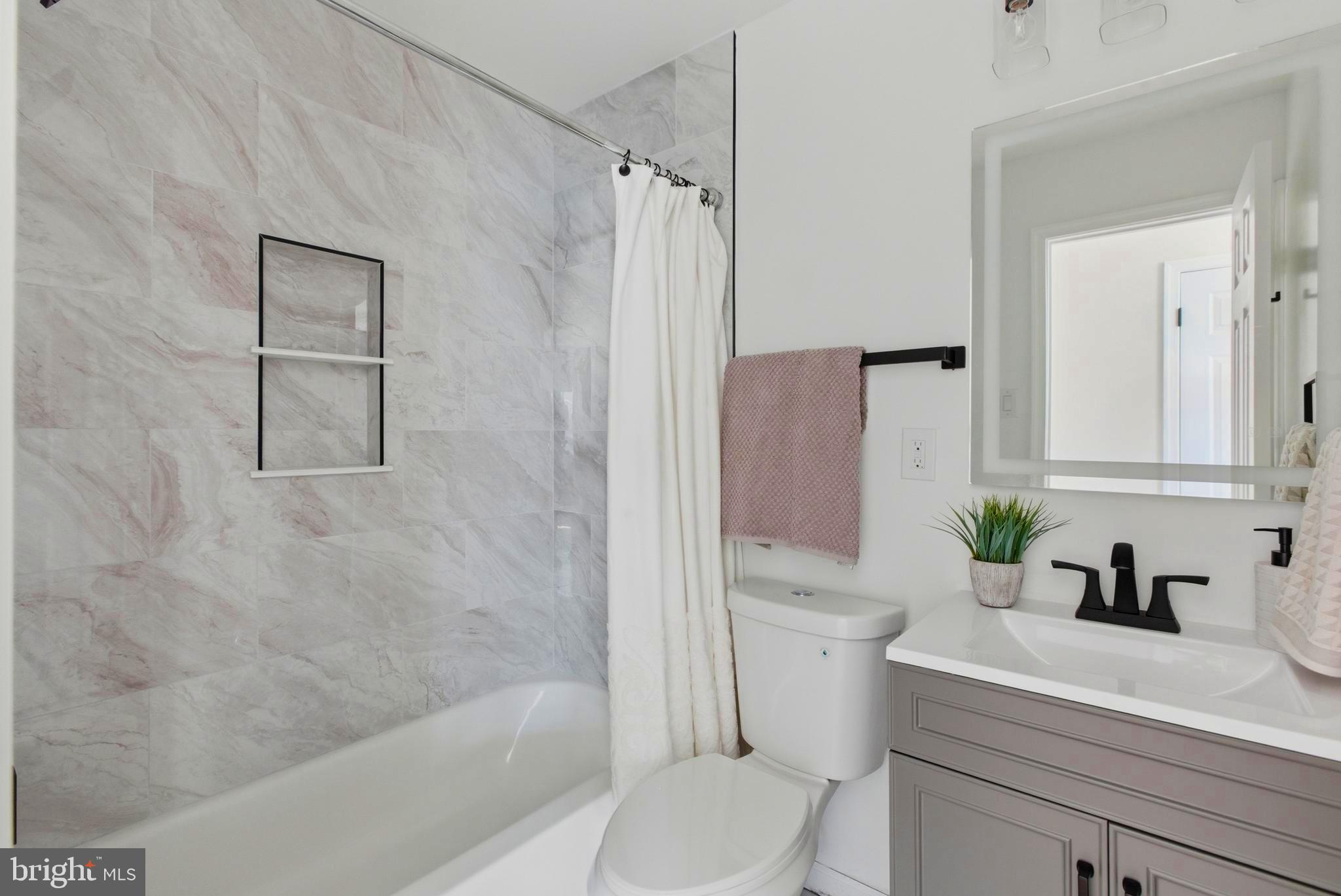 709 Quarry Avenue Capitol Heights, MD 20743 - Photo 19 of 43 a bathroom with a sink a toilet and shower