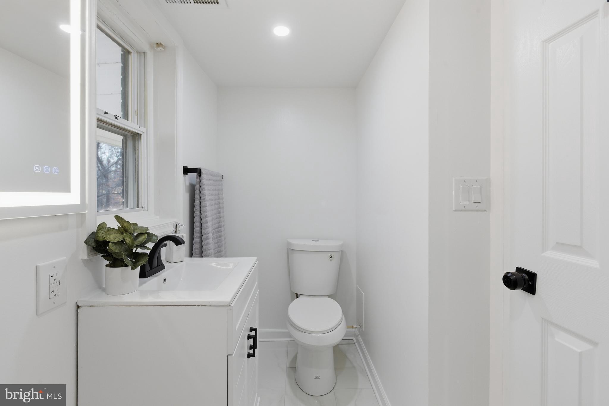 709 Quarry Avenue Capitol Heights, MD 20743 - Photo 36 of 43 a bathroom with a sink a toilet and shower curtain