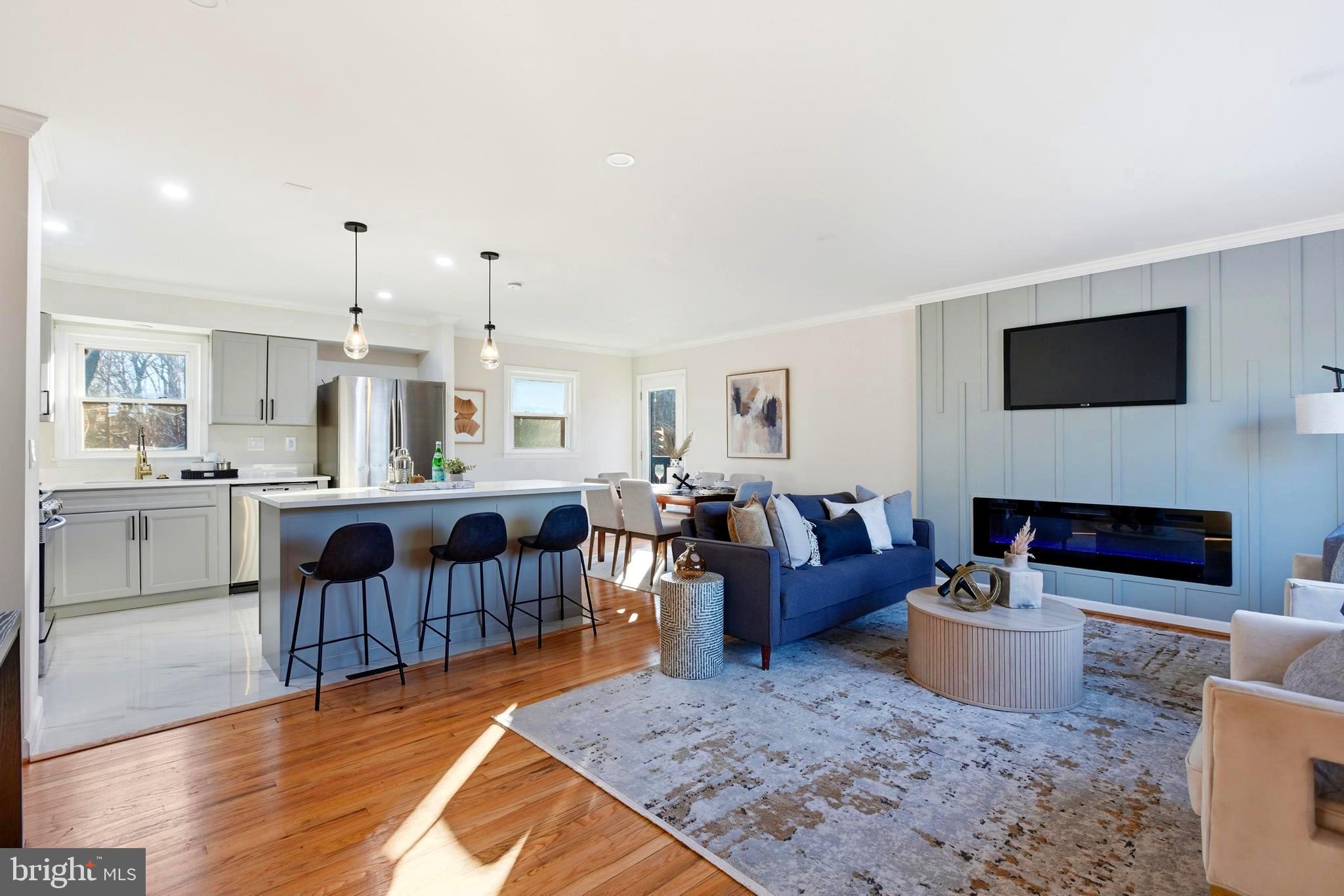 709 Quarry Avenue Capitol Heights, MD 20743 - Photo 4 of 43 a living room with furniture a fireplace a flat screen tv and kitchen view
