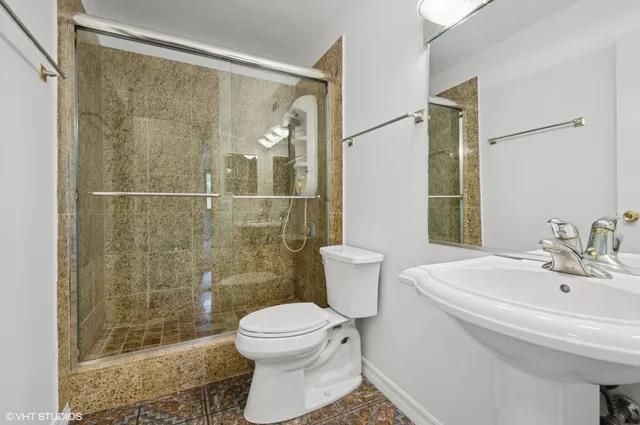 a bathroom with a toilet sink and shower