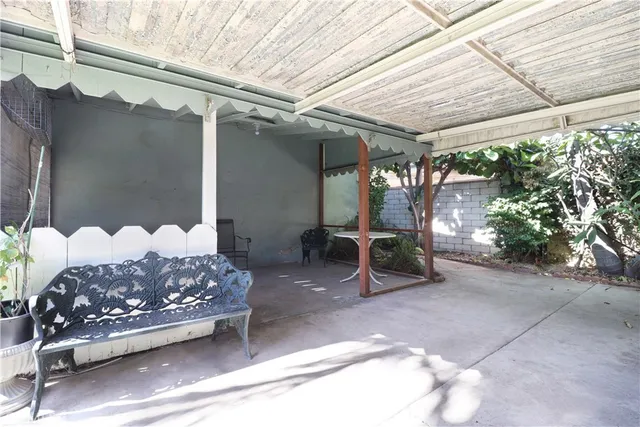 a bedroom with furniture and a potted plant