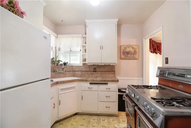 a kitchen with stainless steel appliances a stove and a refrigerator