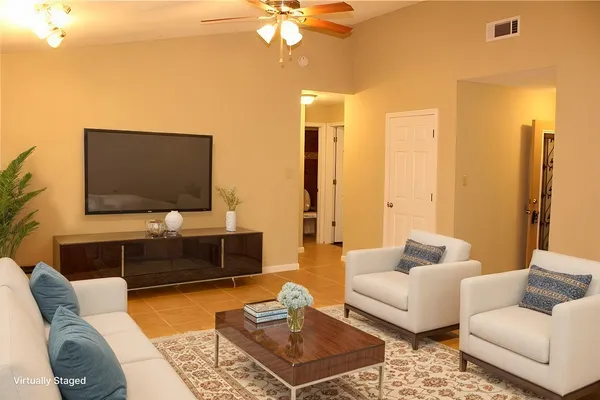 a living room with furniture and a flat screen tv