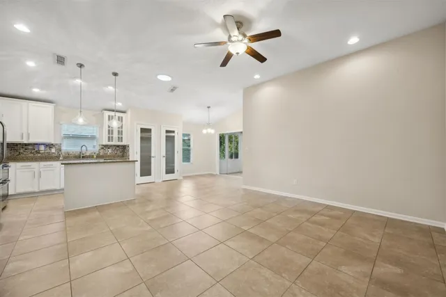 an empty room with closet and a chandelier fan