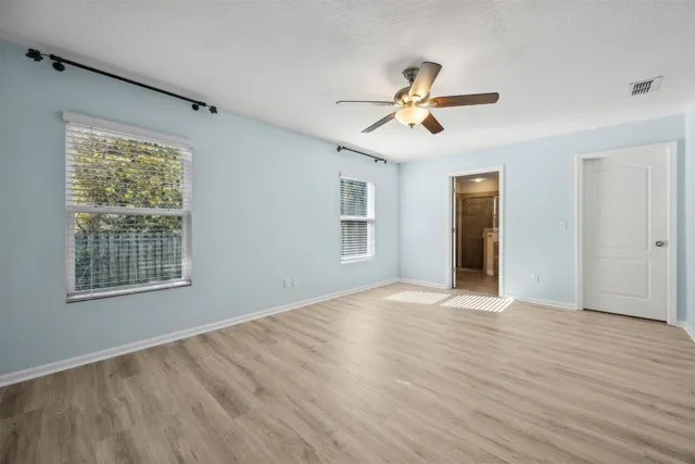 a view of an empty room with a fan