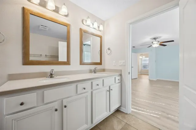 a bathroom with a double vanity sink mirror double and a bathtub