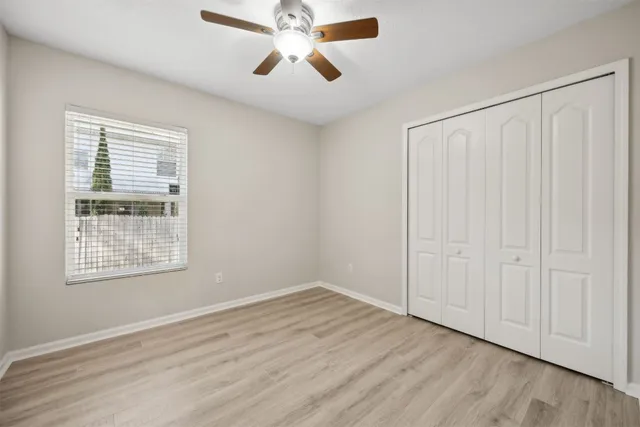 an empty room with a empty space and a ceiling fan