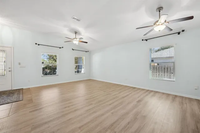 a kitchen with stainless steel appliances granite countertop a refrigerator a stove a sink and a microwave