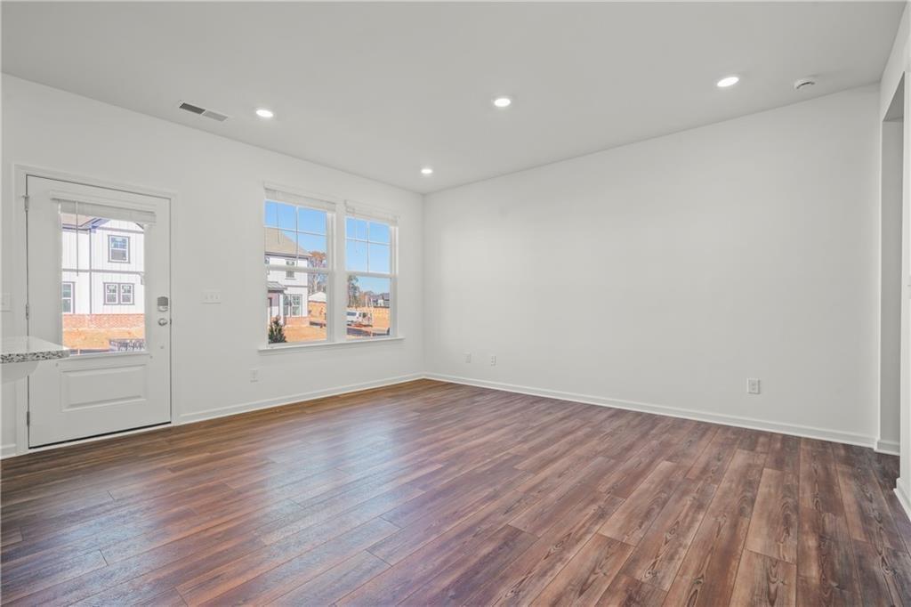 155 Star Court Pendergrass, GA 30567 - Photo 5 of 22 an empty room with wooden floor and windows