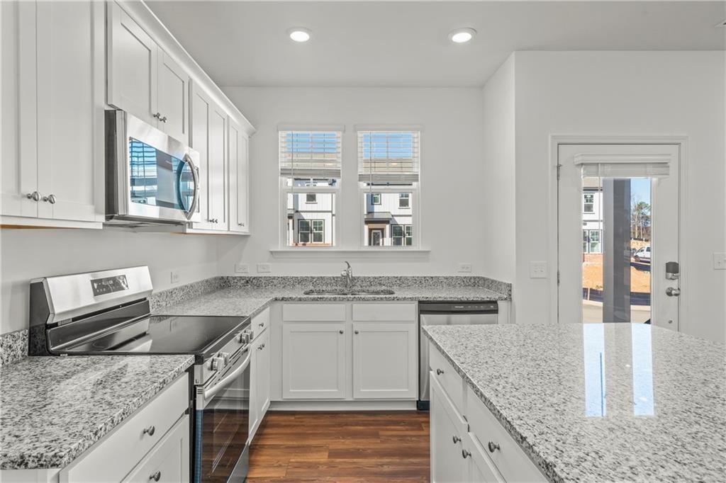 155 Star Court Pendergrass, GA 30567 - Photo 7 of 22 a kitchen with a sink stove and cabinets