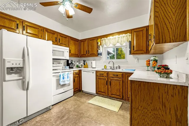 a kitchen with a refrigerator sink and cabinets