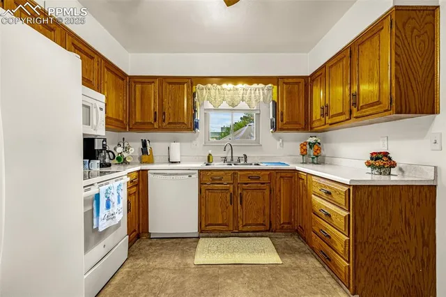 a kitchen with a sink window and cabinets