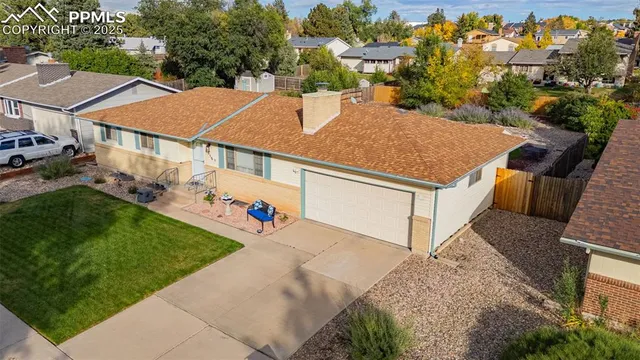 an aerial view of a house with a yard