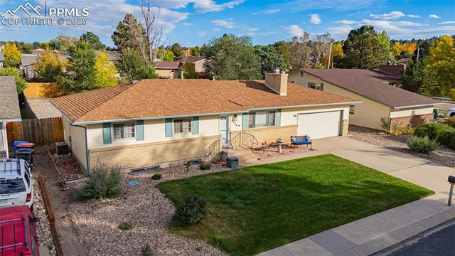 a aerial view of a house with a yard and potted plants