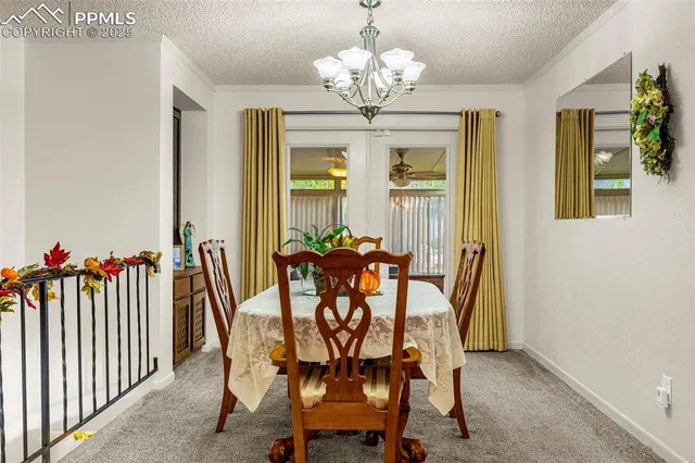 a dining room with furniture and chandelier