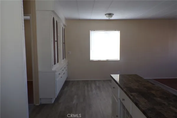 a kitchen with a wooden floor and a window