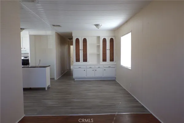 a view of a kitchen with wooden floor and staircase