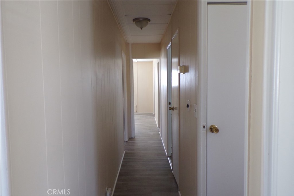 12710 3rd Street, Unit 91 Yucaipa, CA 92399 - Photo 14 of 21 a view of a hallway with wooden floor