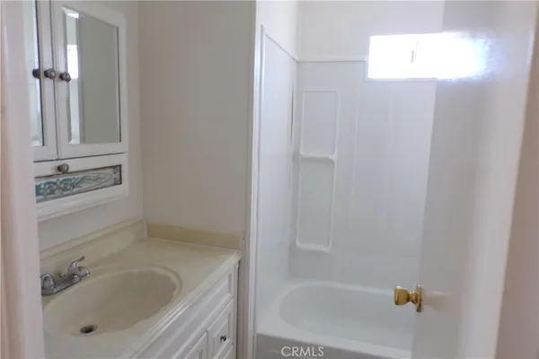a bathroom with a tub and shower