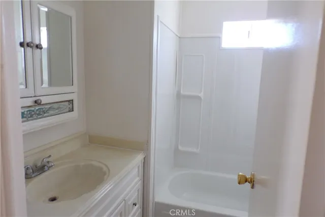 a bathroom with a tub and shower