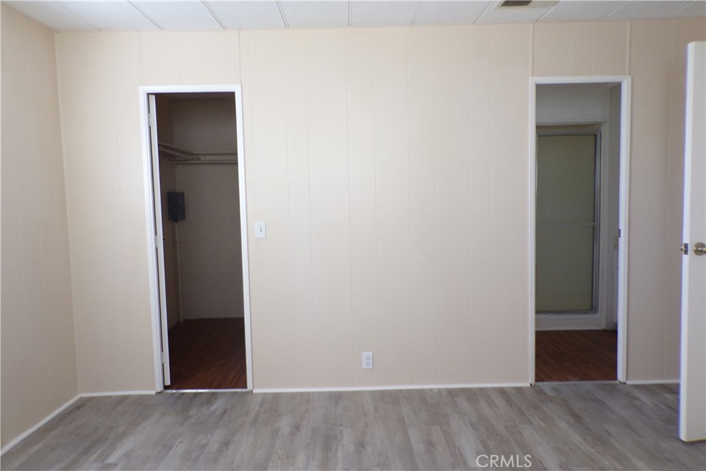 12710 3rd Street, Unit 91 Yucaipa, CA 92399 - Photo 19 of 21 a view of an empty room with wooden floor & closet