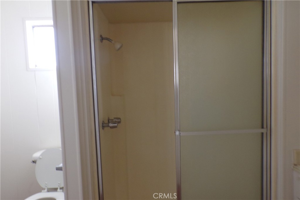 12710 3rd Street, Unit 91 Yucaipa, CA 92399 - Photo 21 of 21 a bathroom with a glass shower door