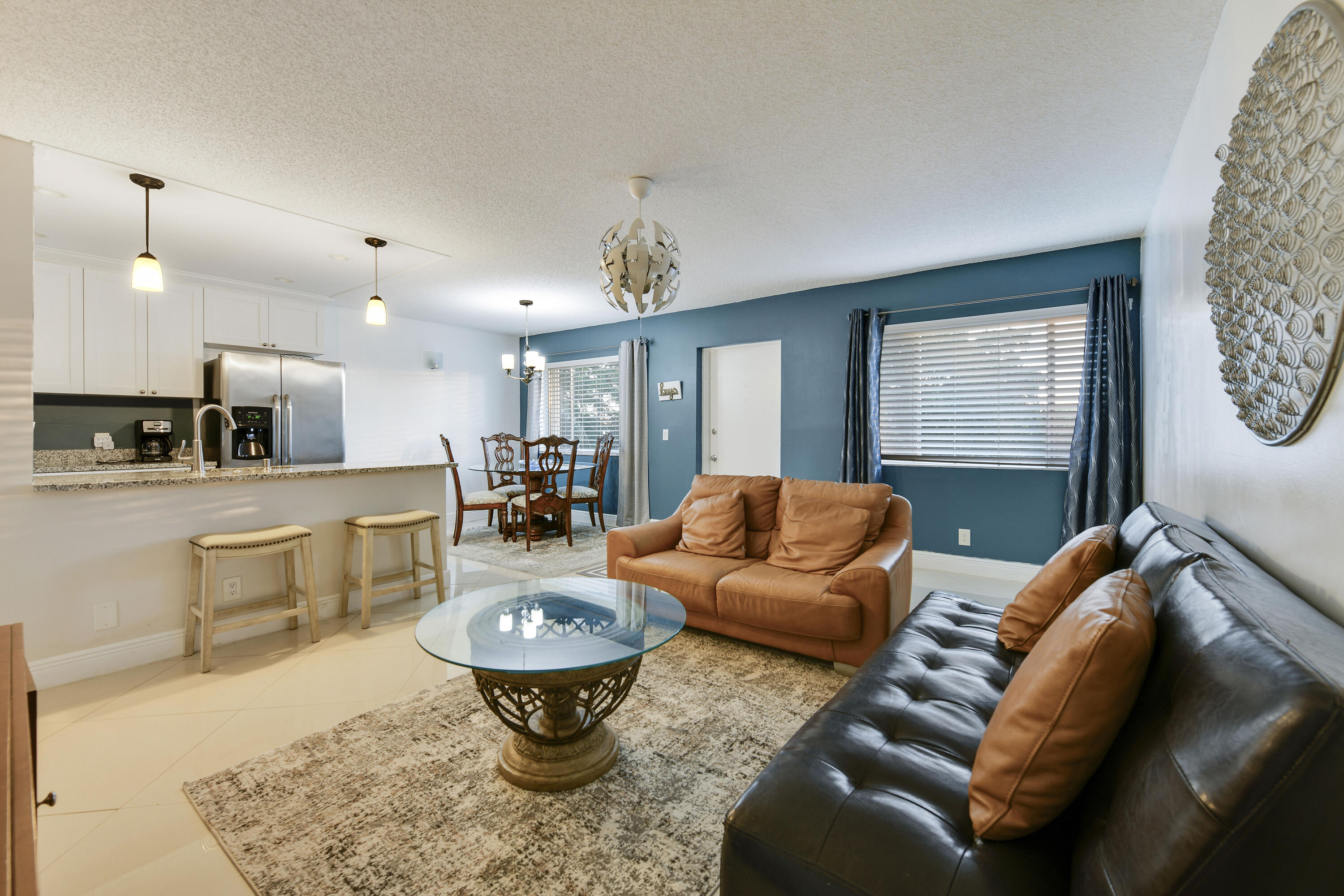 a living room with furniture a window and kitchen view