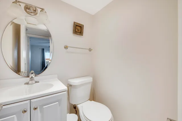 a bathroom with a toilet a sink and mirror