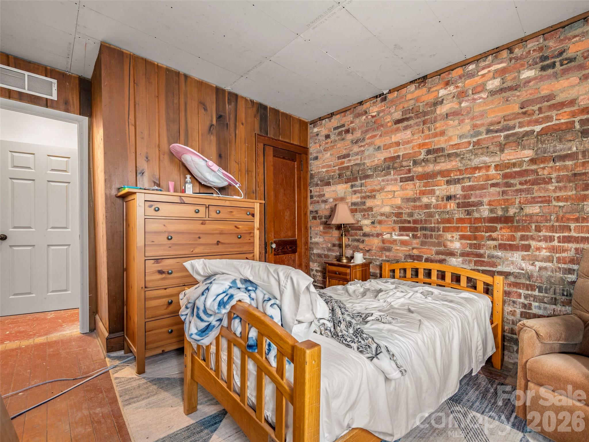 120 East Howard Street Tryon, NC 28782 - Photo 21 of 31 a bedroom with a bed and a dresser